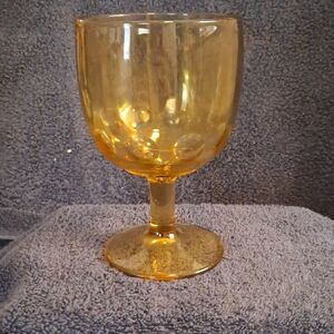 Amber glass thumbprint goblet by Bartlett Collins